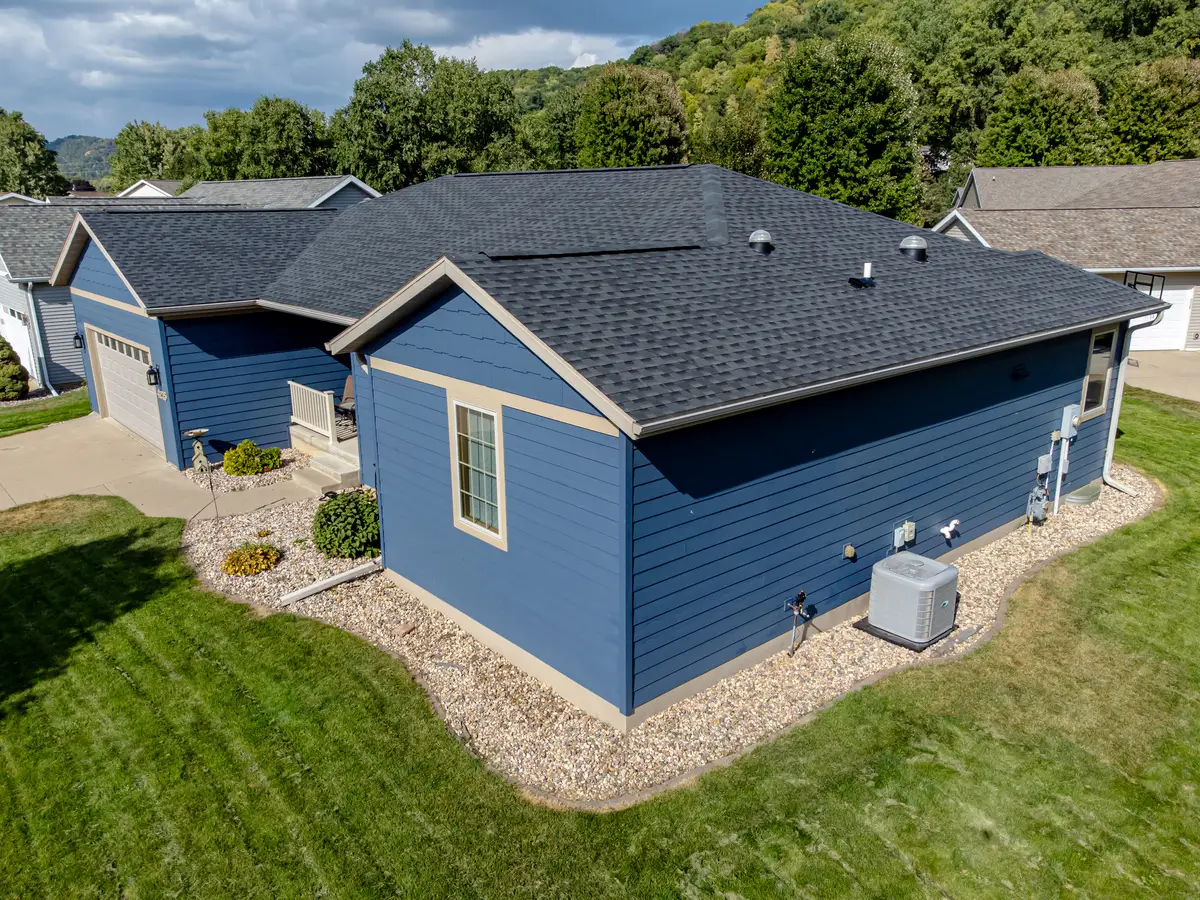 Single-story house with blue fiber cement lap siding and tan trim, seen from above